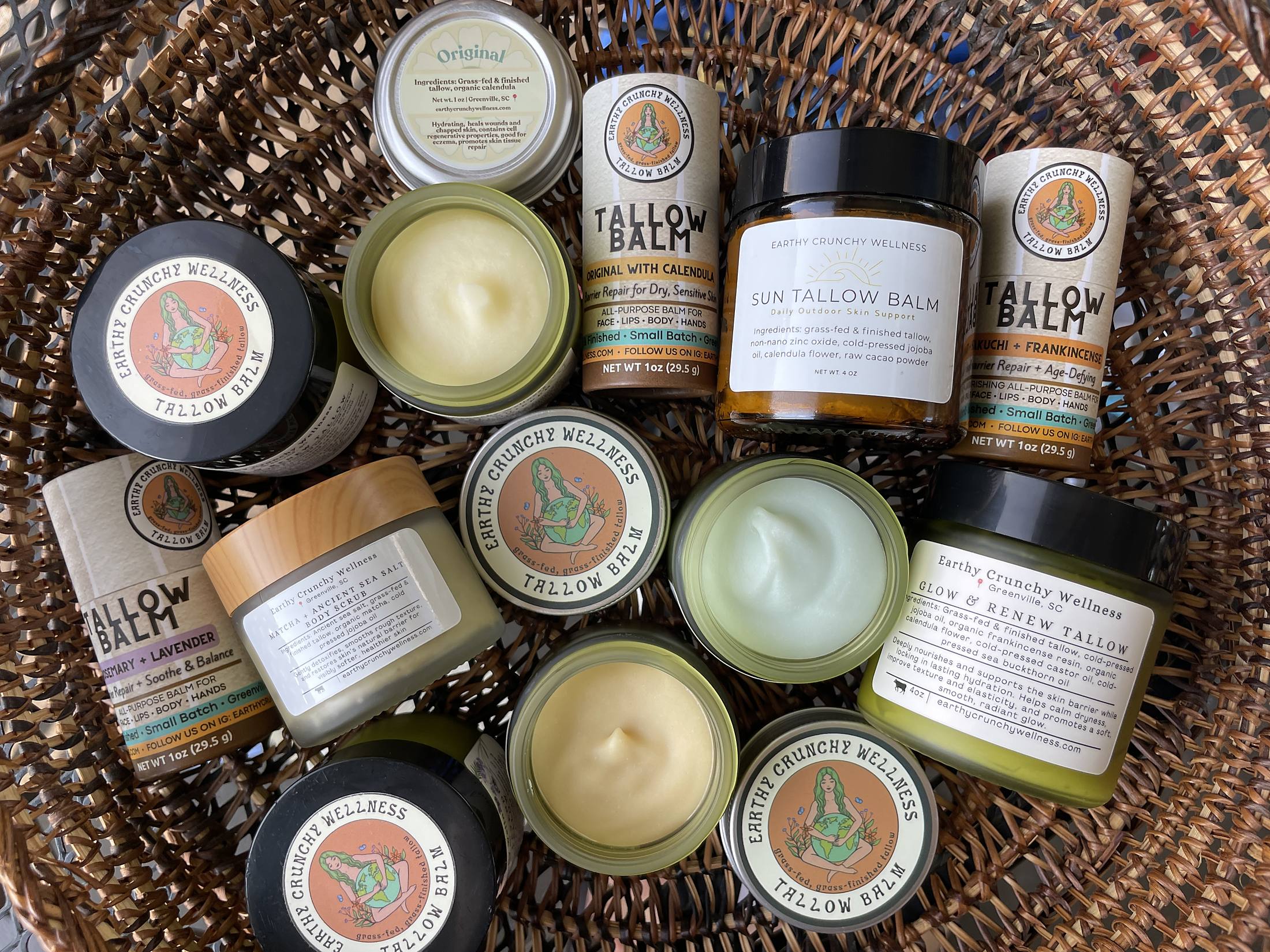The full Earthy Crunchy Wellness line of tallow balms, whipped tallows, sun balm, and matcha scrub in a woven basket