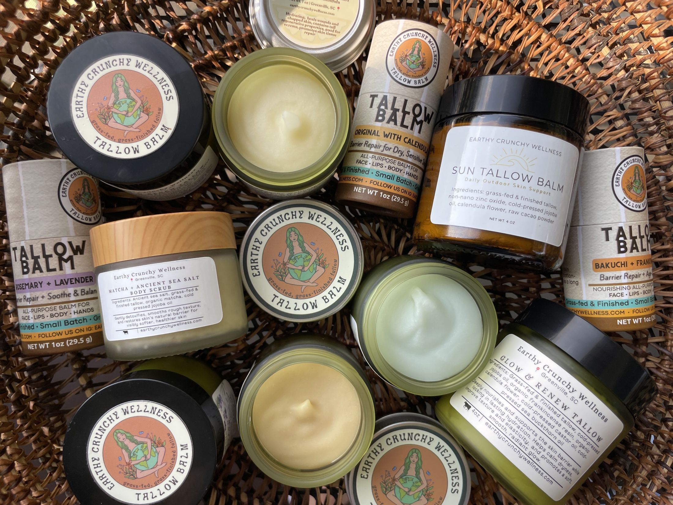 The full Earthy Crunchy Wellness product family arranged in a wicker basket in warm sunlight